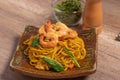 Fried noodles with shrimp in a plate on the table Royalty Free Stock Photo