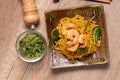 Fried noodles with shrimp in a plate on the table Royalty Free Stock Photo