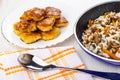 Fried nuggets in plate, mix from mushroom, lentils, rice in frying pan, spoon on napkin on table