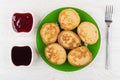 Fried oat pancakes in plate, blueberry jam, strawberry jam, fork Royalty Free Stock Photo