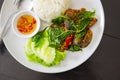 Fried one-thousand-year egg with crispy holy basil and rice dish