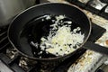 Fried onion in oil in a frying pan. Royalty Free Stock Photo