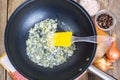 Fried onion in oil in a frying pan Royalty Free Stock Photo