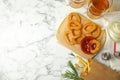 Fried onion rings served on white table, flat lay. Space for text Royalty Free Stock Photo