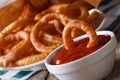 Fried onion rings with tomato sauce closeup, horizontal Royalty Free Stock Photo