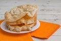 Fried pappadum on a white wooden table