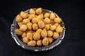 Fried party snacks arranged on a stainless steel plate with black background. top view Royalty Free Stock Photo