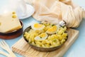 Fried pasta with boiled eggs, cheese and chives