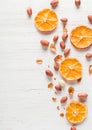 Fried peanut on a white wooden background. Dry slices of citrus.