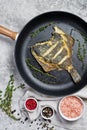 Fried plaice in a pan. Gray background, top view. Royalty Free Stock Photo