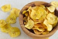 Fried plantain chips in a wooden bowl.