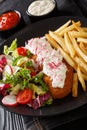 Fried pollock in breading with french fries and fresh salad close-up on a plate. vertical