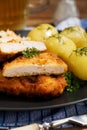 Fried pork chop in breadcrumbs, served with boiled potatoes and cabbage. Royalty Free Stock Photo