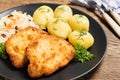 Fried pork chop in breadcrumbs, served with boiled potatoes and cabbage. Royalty Free Stock Photo