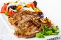 Fried pork chops with salad of fried orange, vegetables and onion