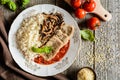 Fried pork cutlets with rice, tomato and mushrooms