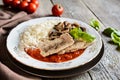 Fried pork cutlets with rice, tomato and mushrooms