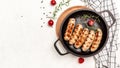 Fried pork Sausage with herbs in a cast iron pan. banner, menu, recipe place for text, top view Royalty Free Stock Photo