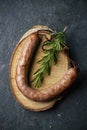 Fried pork sausage on a tree trunk slice