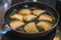 Fried Portuguese or Brazilian rissoles in a frying pan