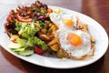 Fried potatatoes with mixed salad and fried eggs Royalty Free Stock Photo