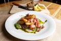 Fried potato with bacon and green beans on plate over wooden background. selective focus Royalty Free Stock Photo