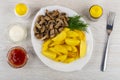 Fried potato, mushroom, dill in plate, ketchup and mayonnaise, p