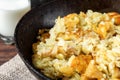 Fried potato in pan on dark wooden background. Belarusian and Russian cuisine.