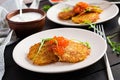 Fried potato pancakes with red caviar and sour cream fritter roesti.