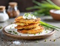 Fried potato pancakes with sour cream and chives. Sprinkled with salt and pepper. Vegetarian dish Royalty Free Stock Photo