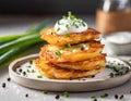 Fried potato pancakes with sour cream and chives. Sprinkled with salt and pepper. Vegetarian dish Royalty Free Stock Photo