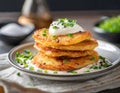 Fried potato pancakes with sour cream and chives. Sprinkled with salt and pepper. Vegetarian dish Royalty Free Stock Photo