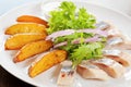 Fried potato with pickled herring Royalty Free Stock Photo