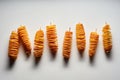 Top view of yummy crispy deep-fried tornado fries or twist potatoes on skewers on a white surface