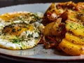 Fried potatoes with bacon cubes and fried eggs Royalty Free Stock Photo