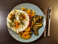 Fried potatoes with bacon cubes and fried eggs Royalty Free Stock Photo