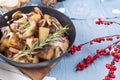 Fried potatoes in a black frying pan with a wooden handle on a b Royalty Free Stock Photo