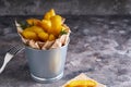Fried potatoes country style. Barbecue potatoes. In a metallic bowl on a gray background Copyspace Royalty Free Stock Photo