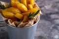 Fried potatoes country style. Barbecue potatoes. In a metallic bowl on a gray background Copyspace Royalty Free Stock Photo