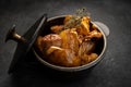 Fried potatoes with garlic and spices in a small cast-iron pot