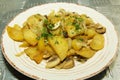 Fried potatoes with herbs and mushrooms