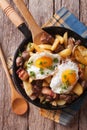 Fried potatoes with meat and eggs in a pan close-up. vertical to Royalty Free Stock Photo