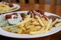 Fried potatoes with meat and salad