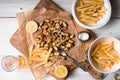 Fried potatoes, mussels, lemon on parchment and beer