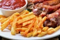 Fried potatoes, pork ribs and tomato sauce Royalty Free Stock Photo