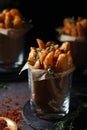 Fried potatoes served in glasses in rustic style