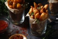 Fried potatoes served in glasses in rustic style