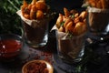 Fried potatoes served in glasses in rustic style