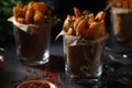 Fried potatoes served in glasses in rustic style