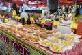 fried potatoes, shrimp fries and fried chicken. rows with portions of ready-made delicious food at the evening market in Royalty Free Stock Photo